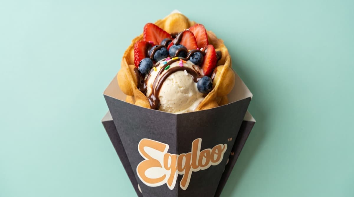 Egg waffle topped with ice cream and fresh fruit