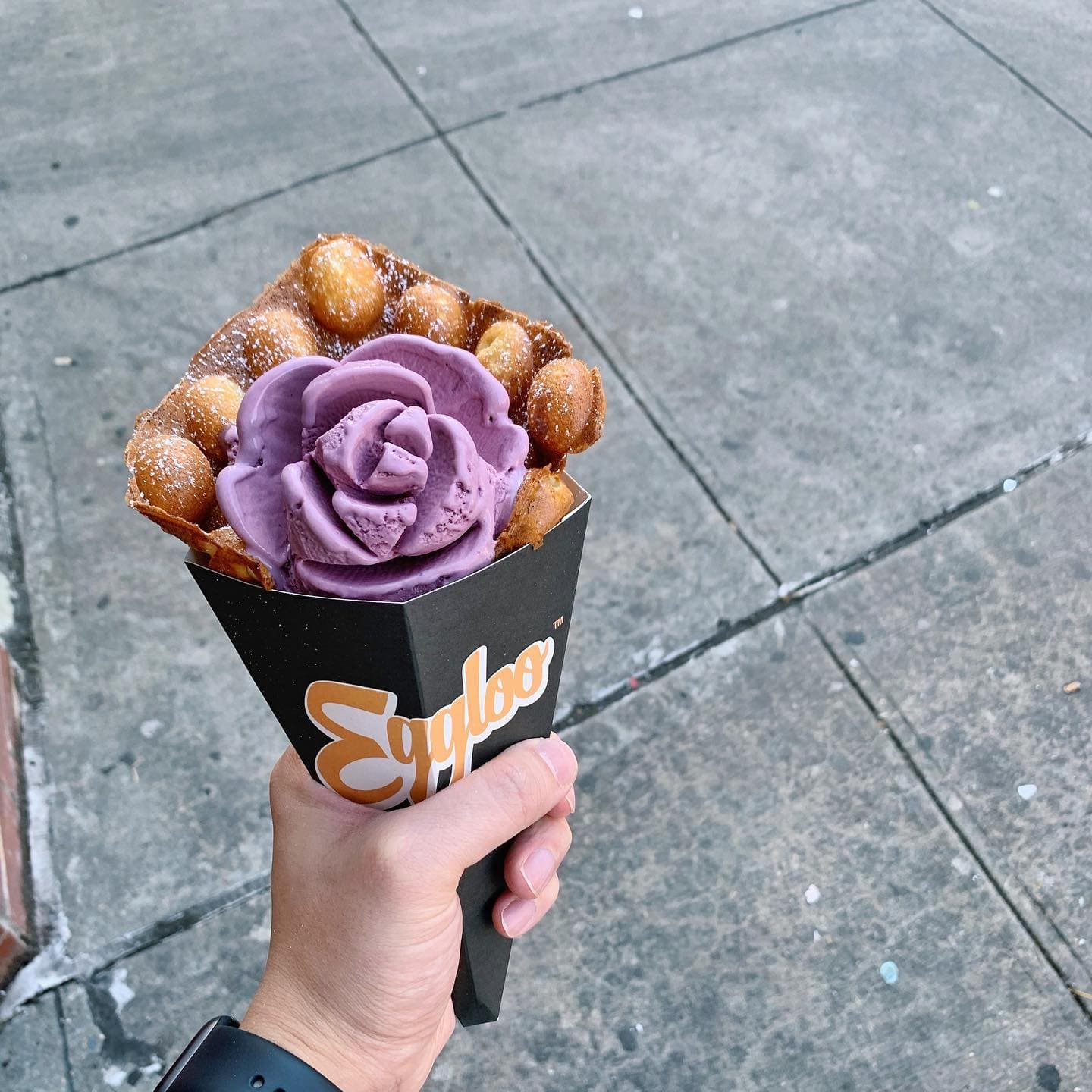 Ube ice cream rose in an Eggloo egg waffle cone